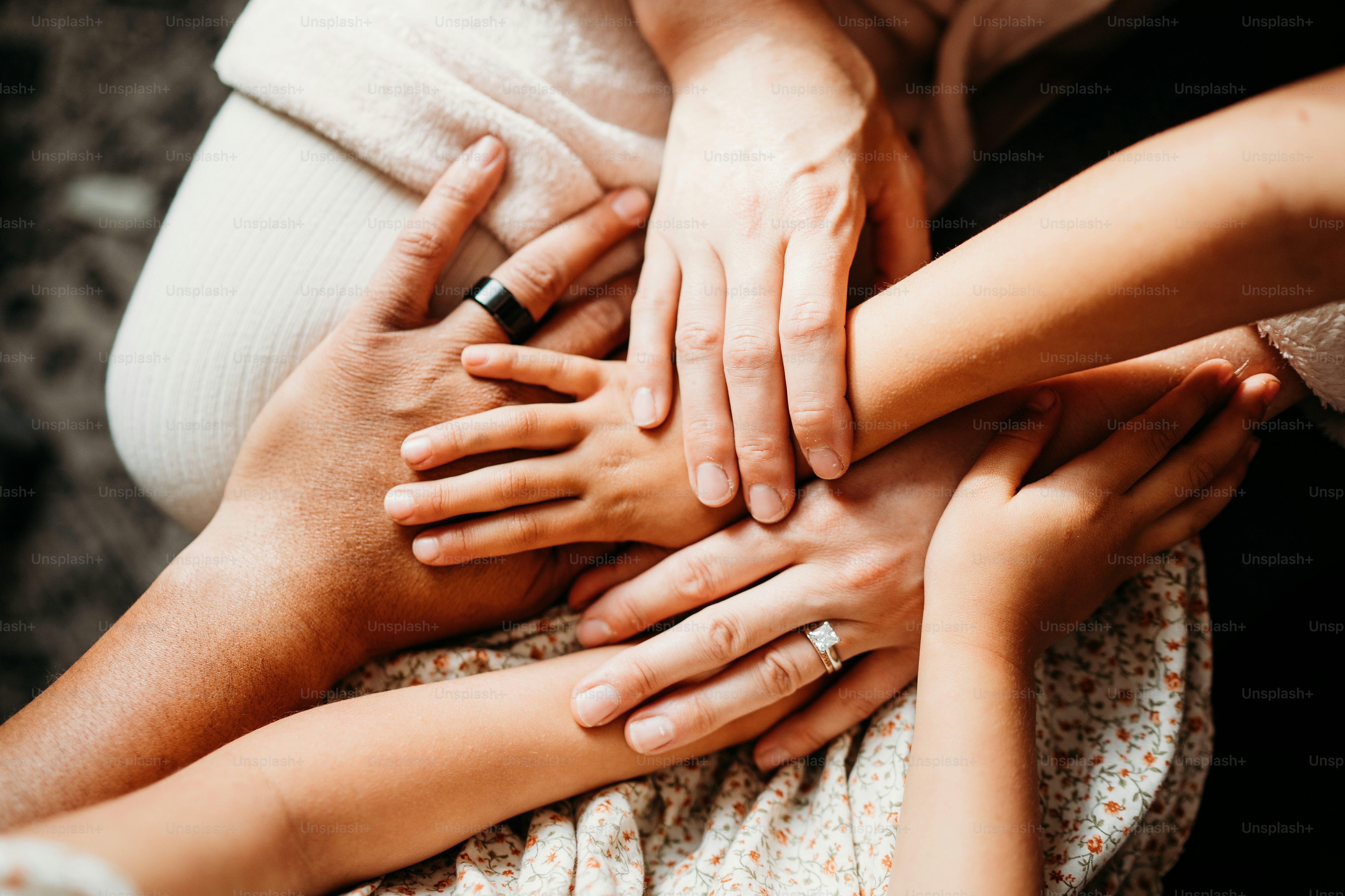 a group of people stacking their hands together
