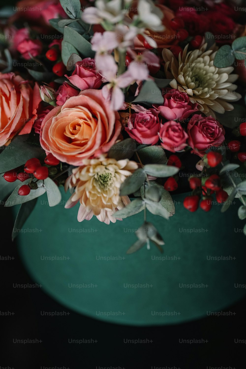 um close up de um vaso com flores em uma mesa