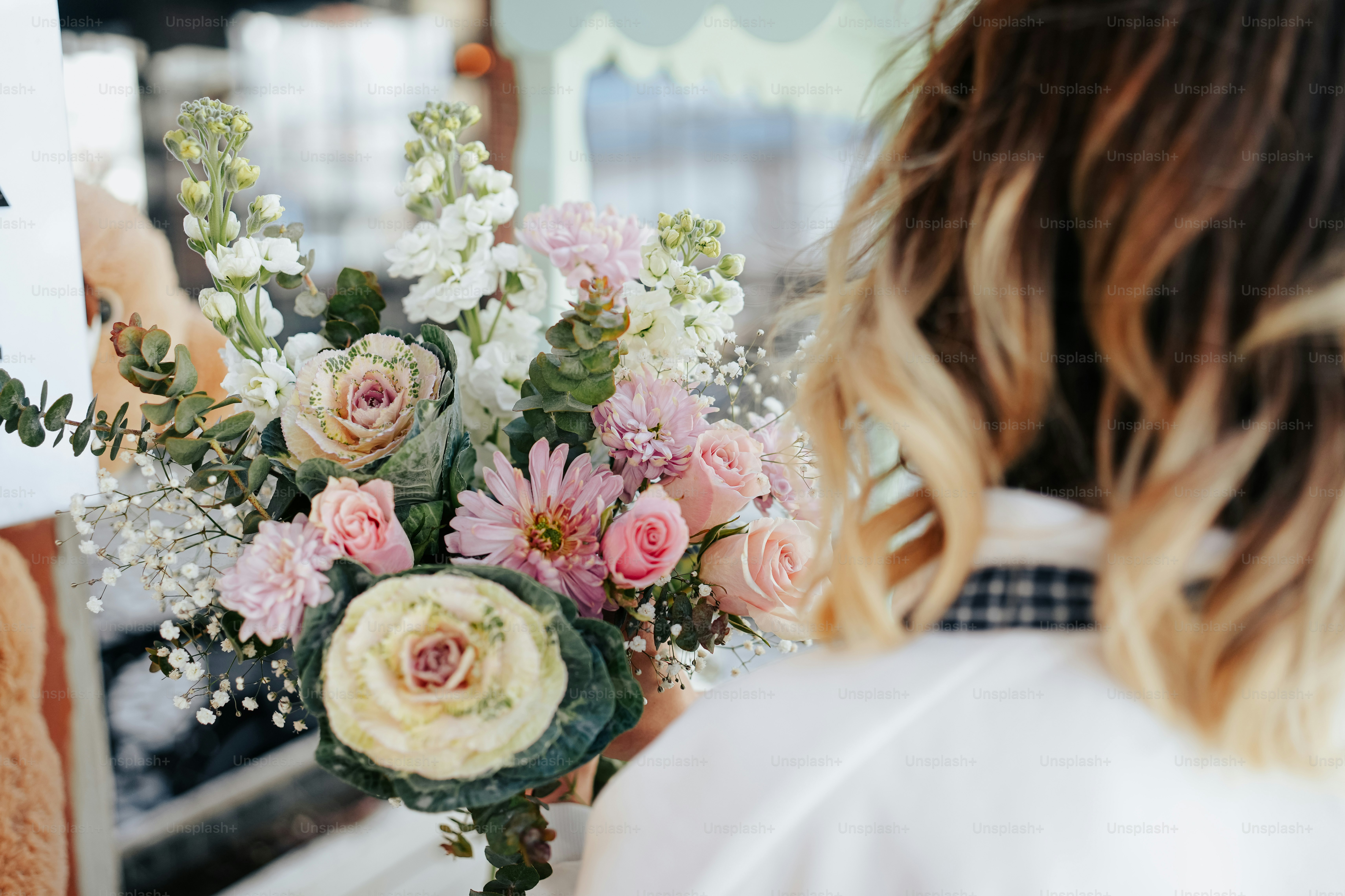 a woman holding a bouquet of flowers in her hand