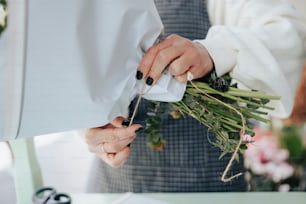 a close up of a person holding a bunch of flowers