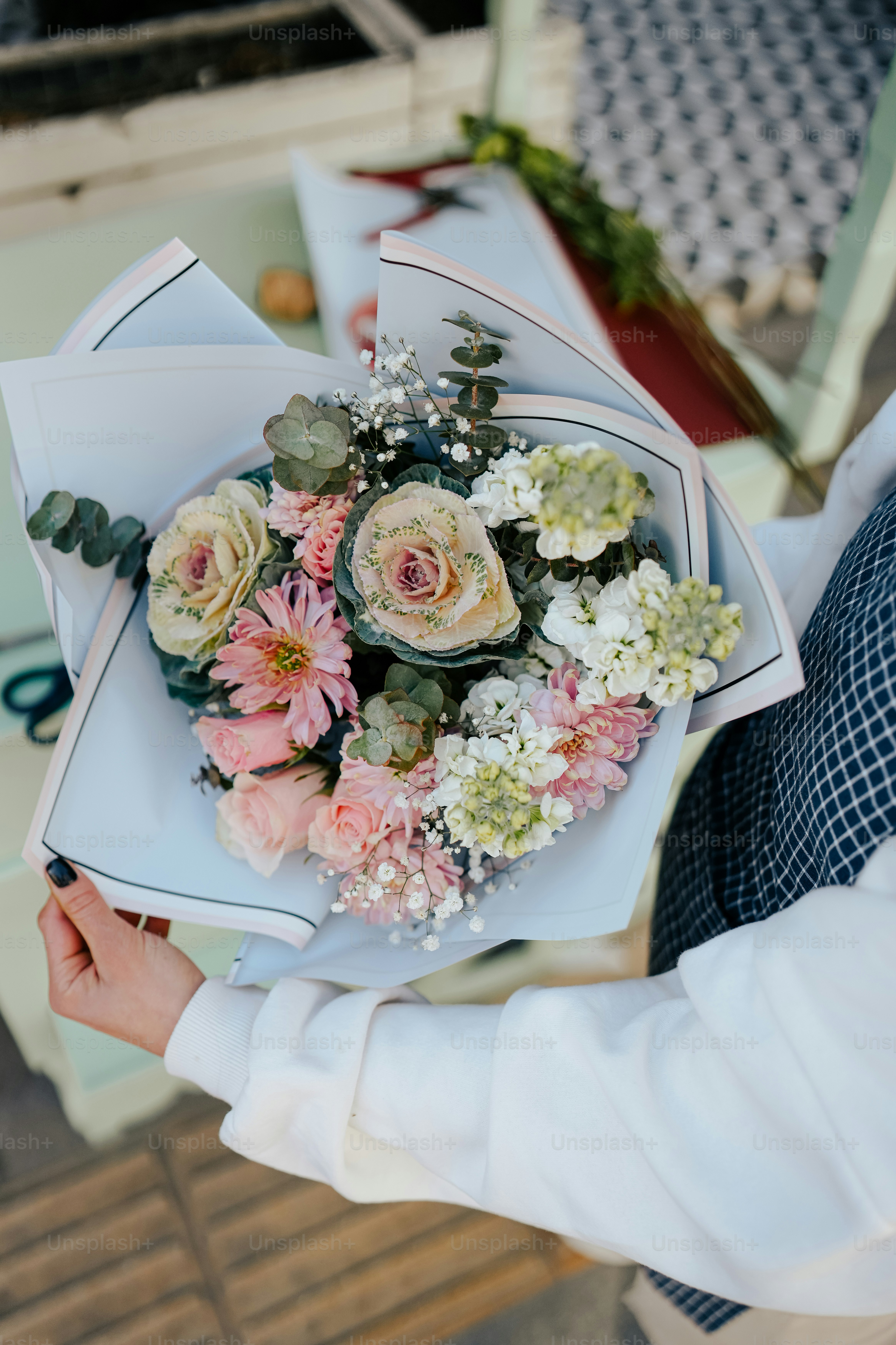a person holding a bouquet of flowers in their hands
