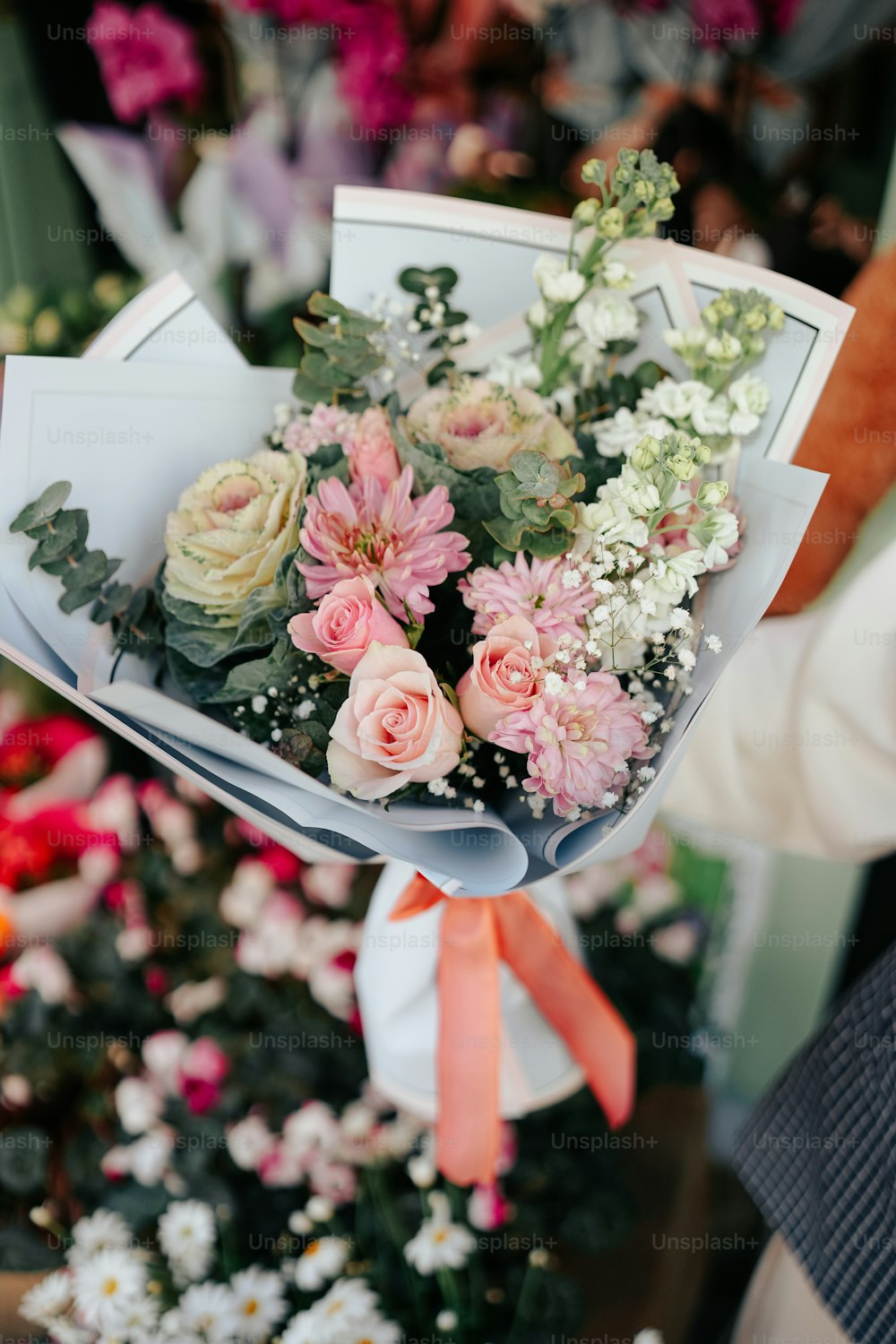 a person holding a bouquet of flowers in their hand