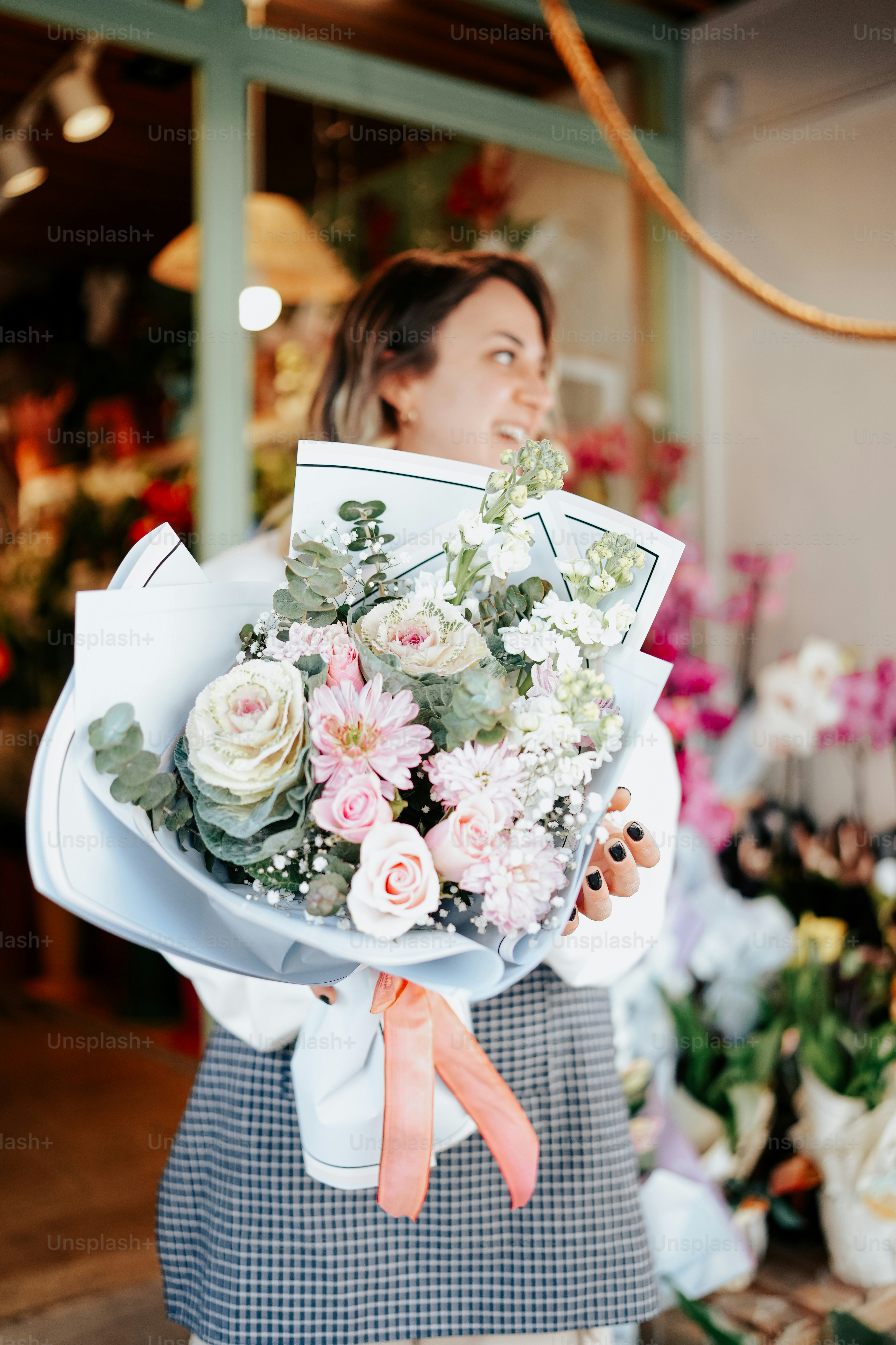 a woman holding a bouquet of flowers in her hands