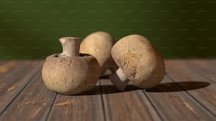 a couple of mushrooms sitting on top of a wooden table