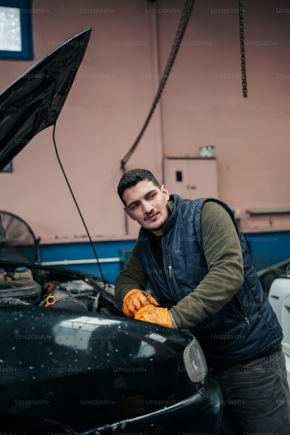 a man working on a car in a garage