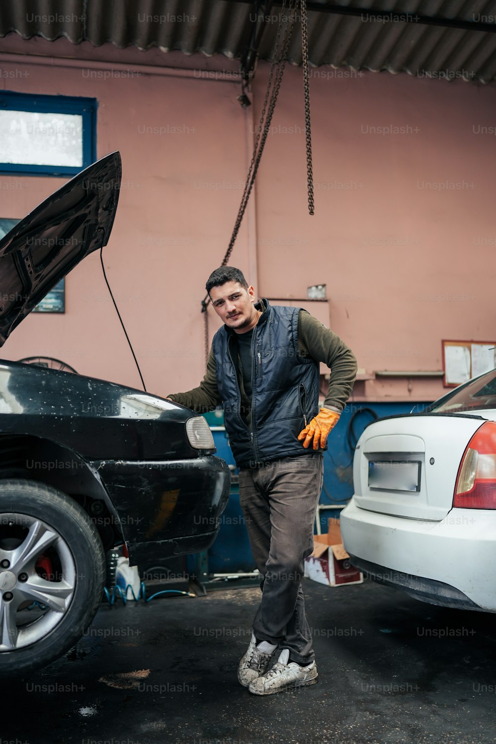 a man standing next to a parked car