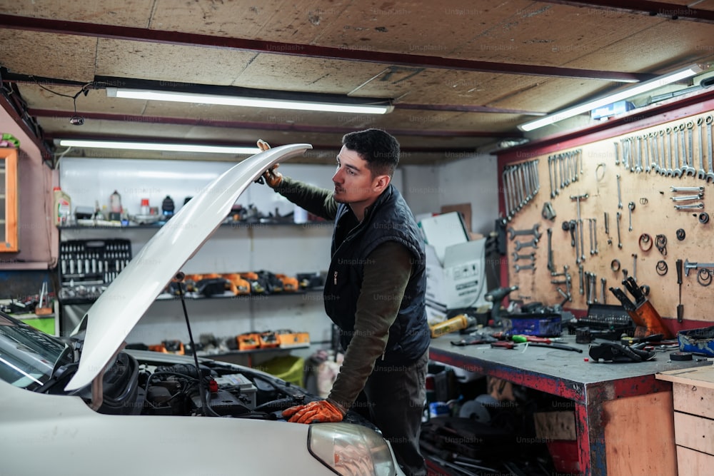 a man working on a car in a garage