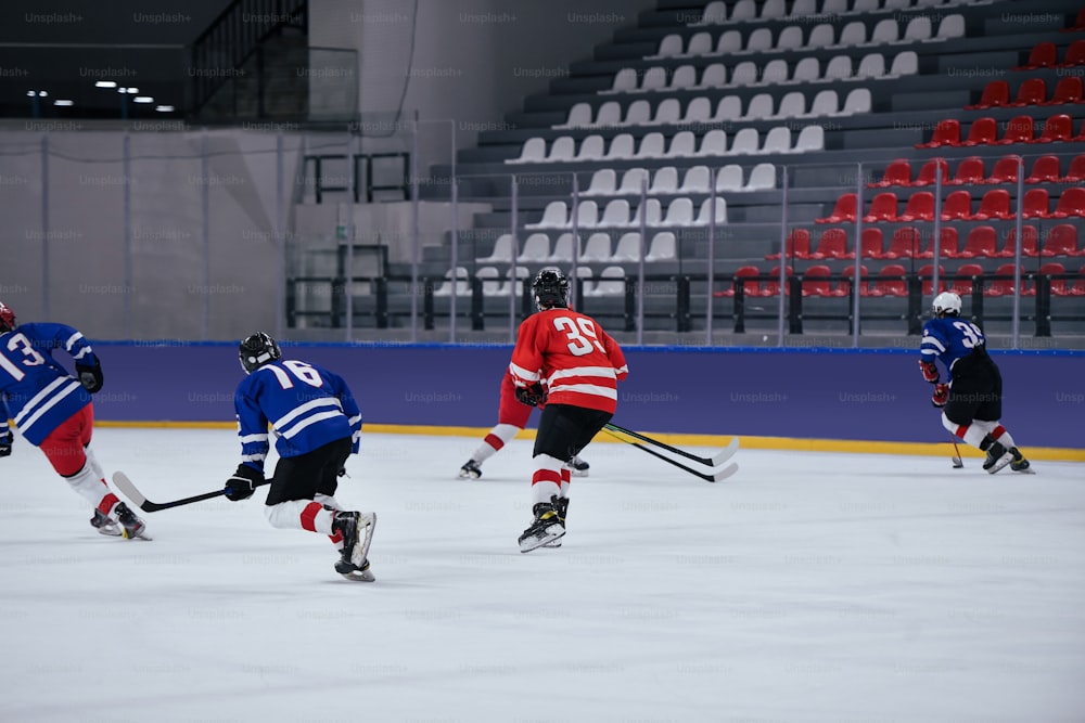 a group of young men playing a game of ice hockey