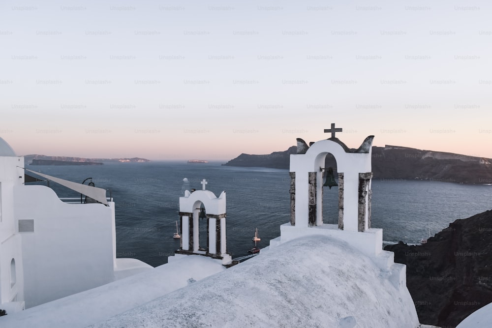 a couple of white buildings sitting on top of a snow covered hillside