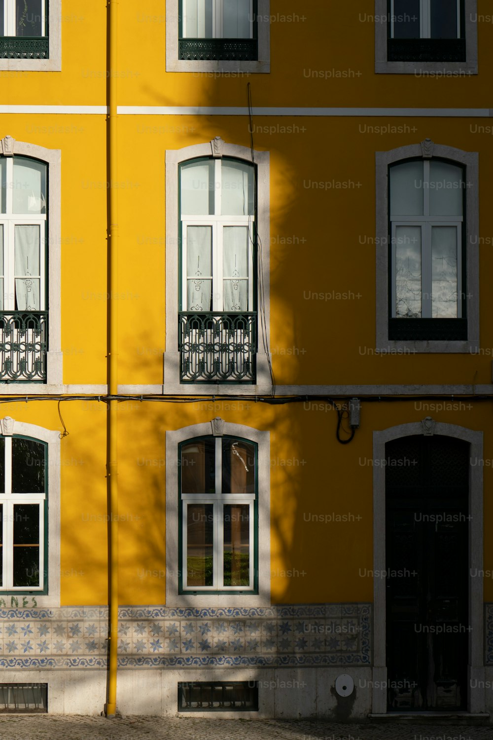 a yellow building with a clock on the front of it