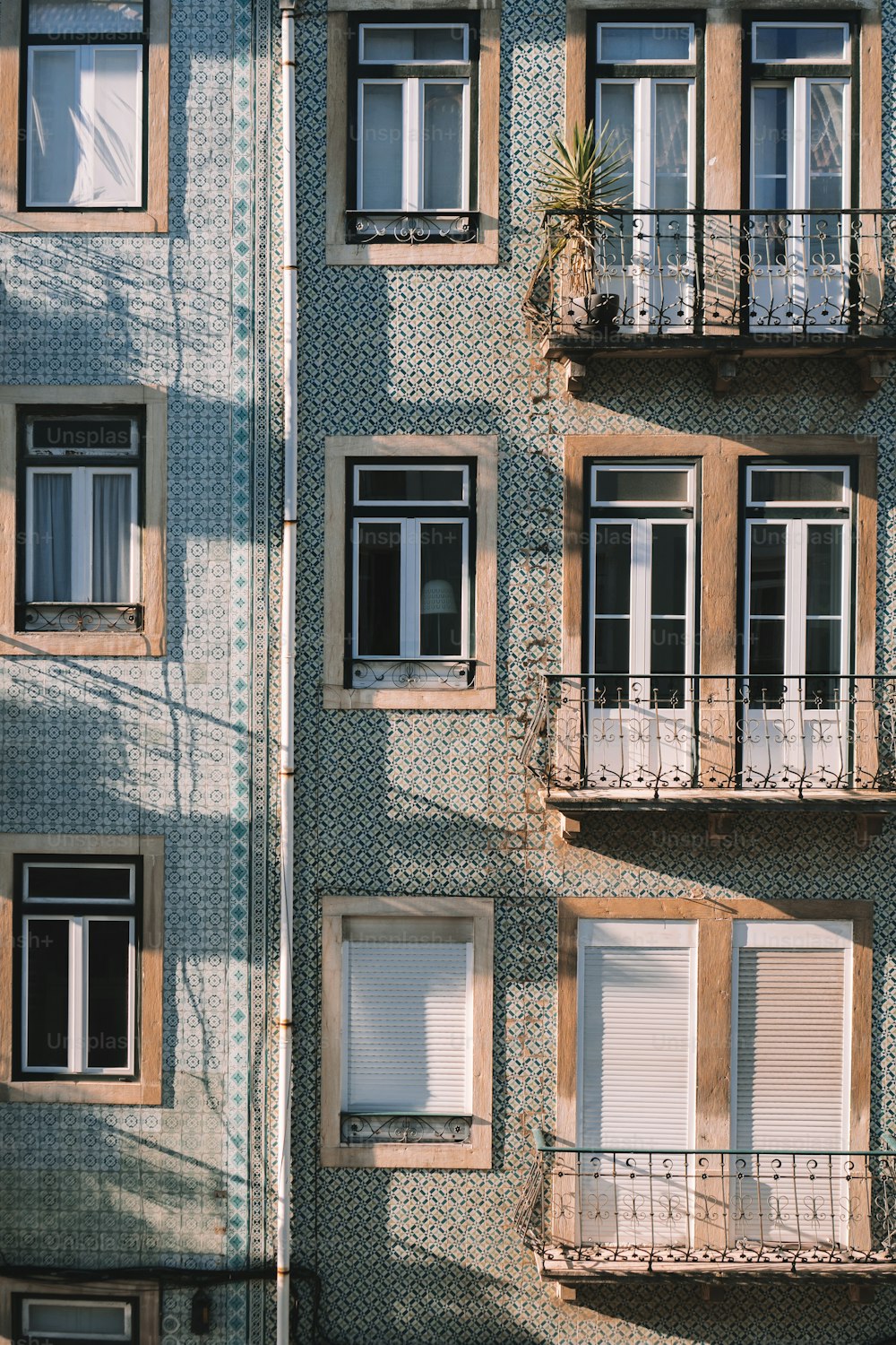 a tall building with lots of windows and balconies