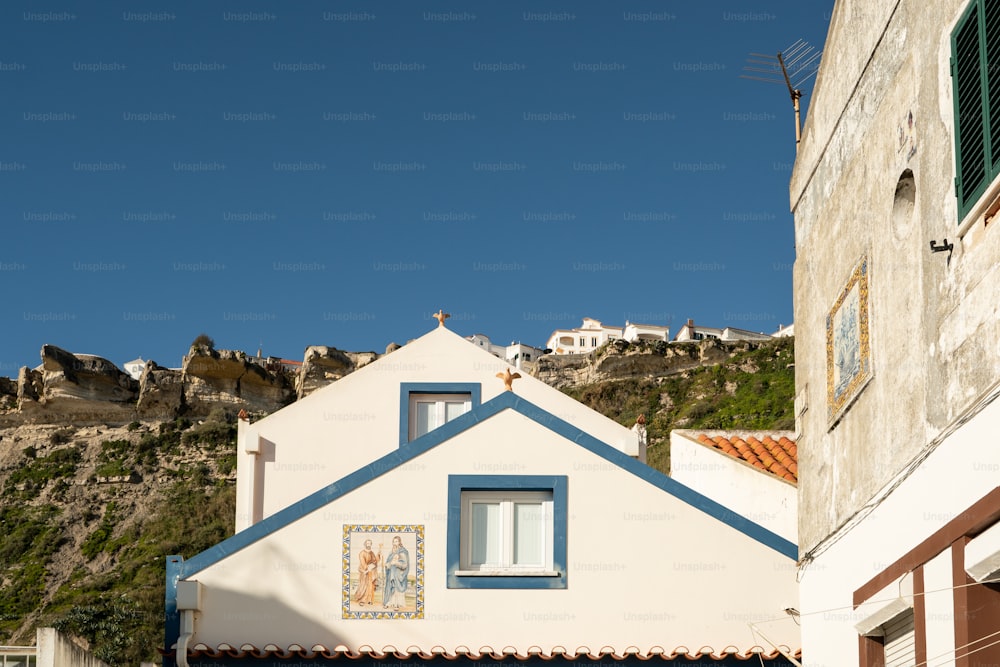 a white house with a blue roof and windows