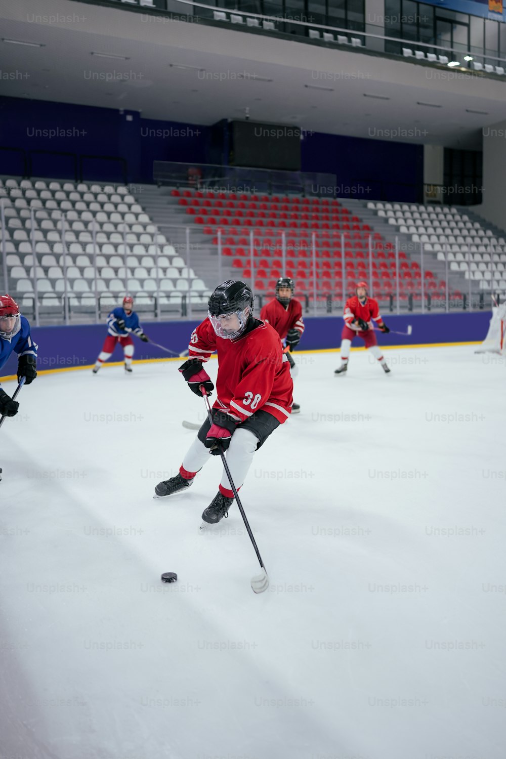 a group of young men playing a game of ice hockey