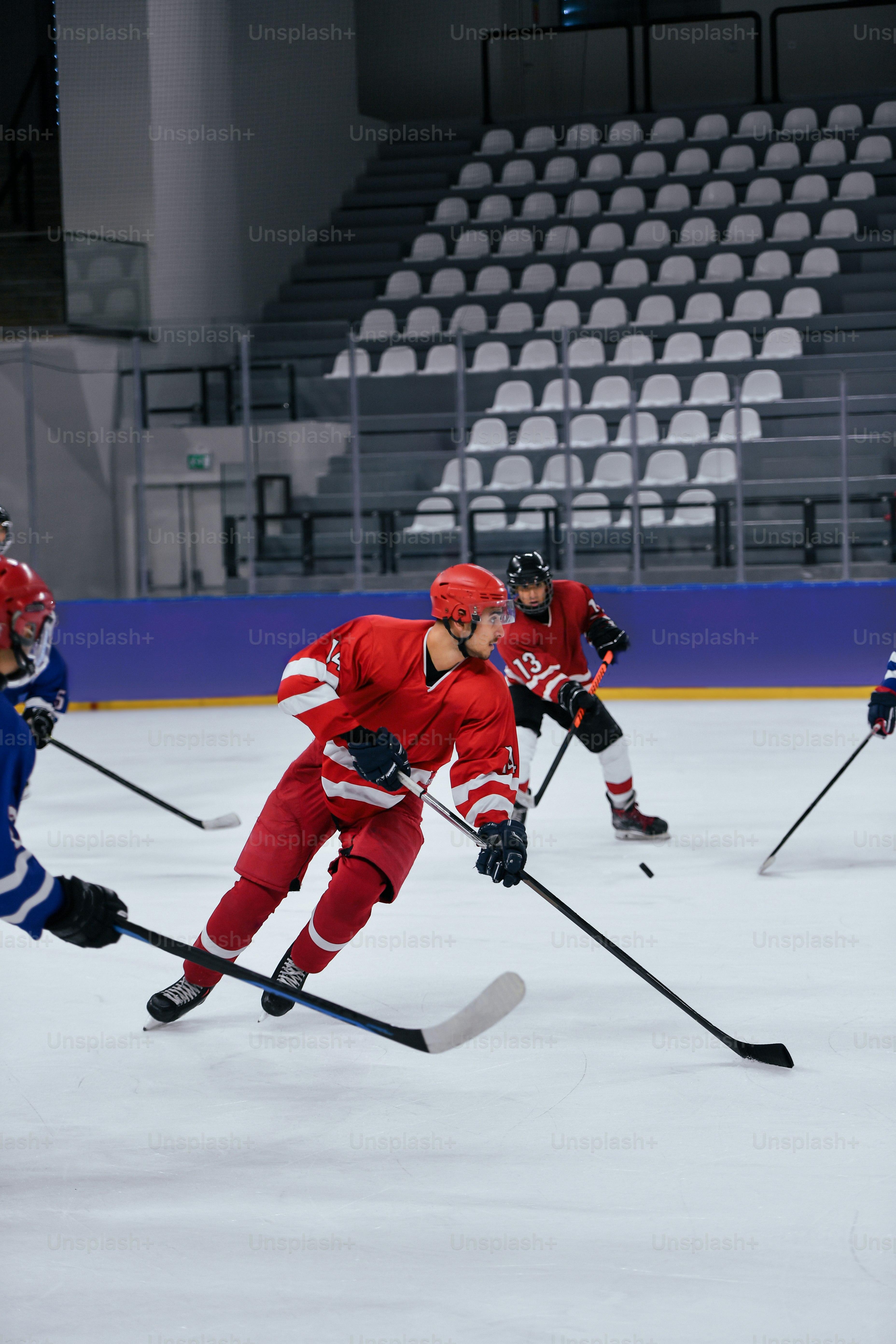 a group of young men playing a game of ice hockey