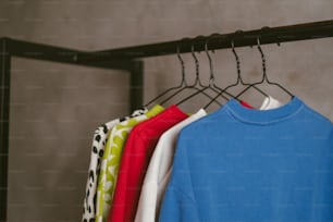 a rack of shirts hanging on a rail