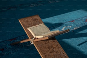 a wooden cross with an open book on it