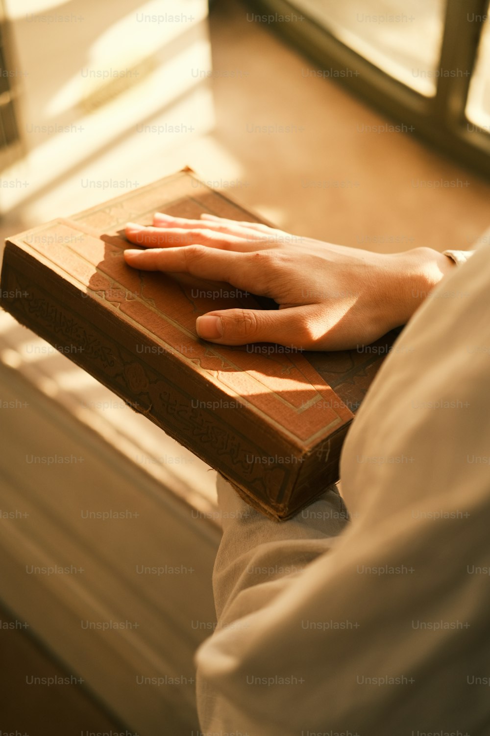 a person's hand resting on top of a book