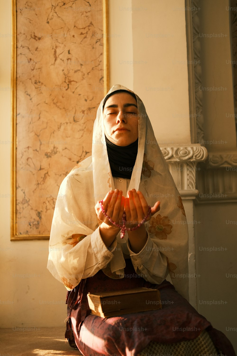 a woman sitting on the ground holding a piece of fruit