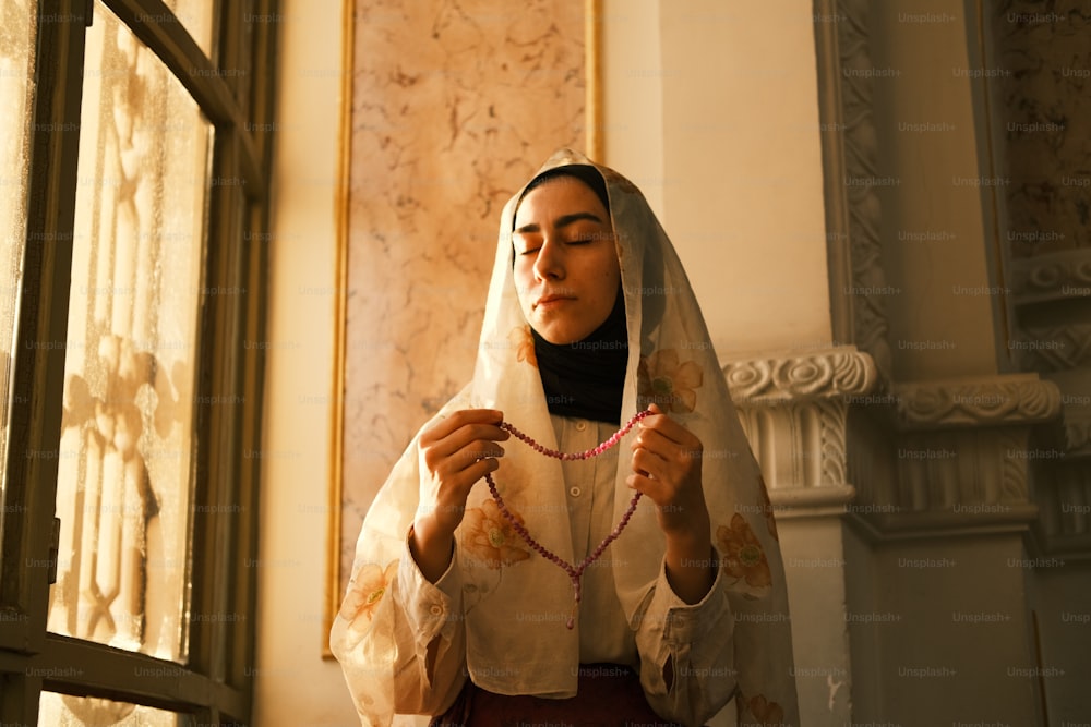 a woman wearing a veil and holding a string