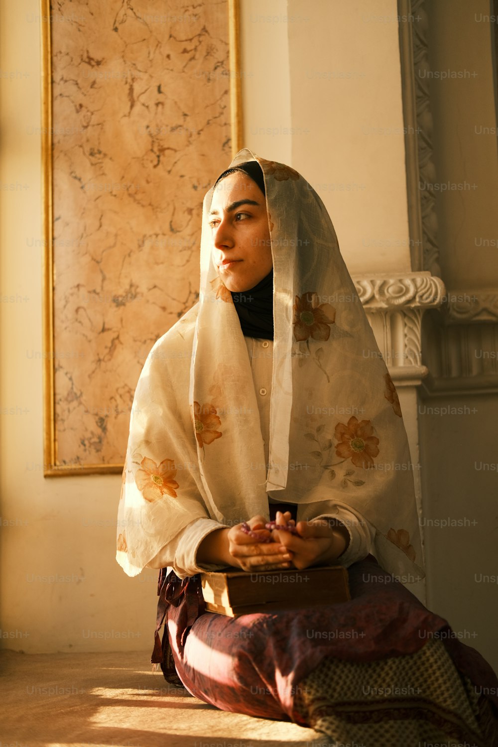 a woman in a white veil sitting on the floor