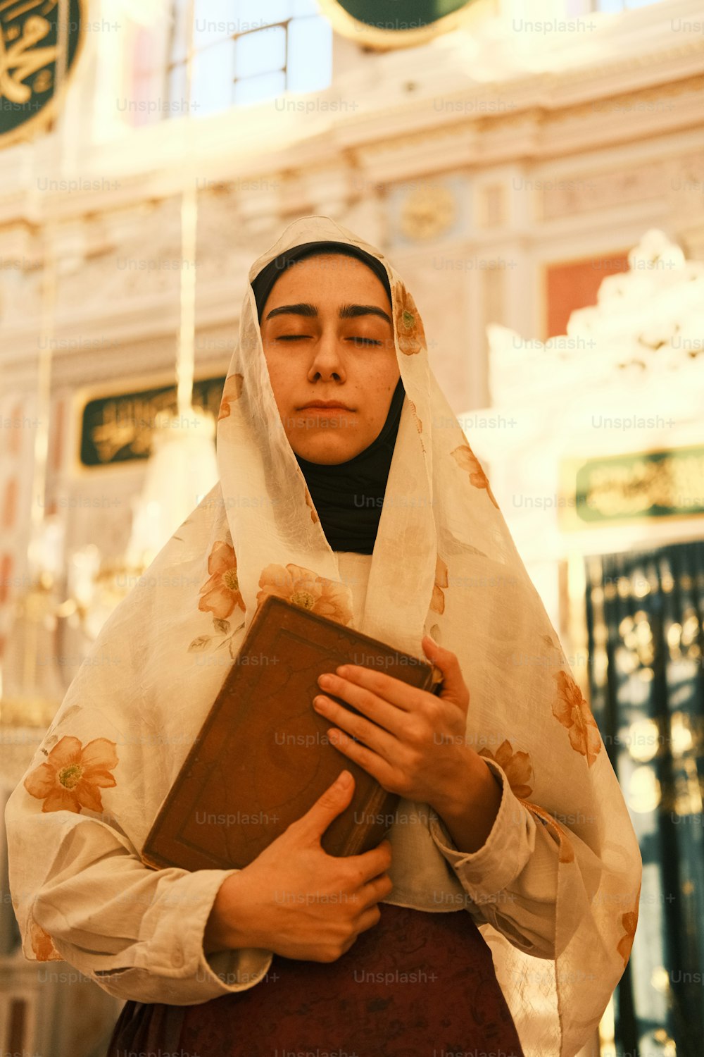 a woman wearing a veil holding a book