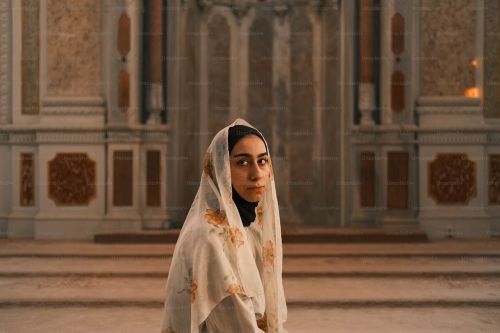 a woman in a white veil standing in a church