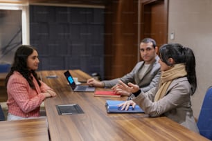 a group of people sitting around a conference table