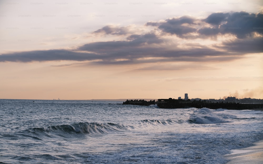 a body of water with a lighthouse in the distance