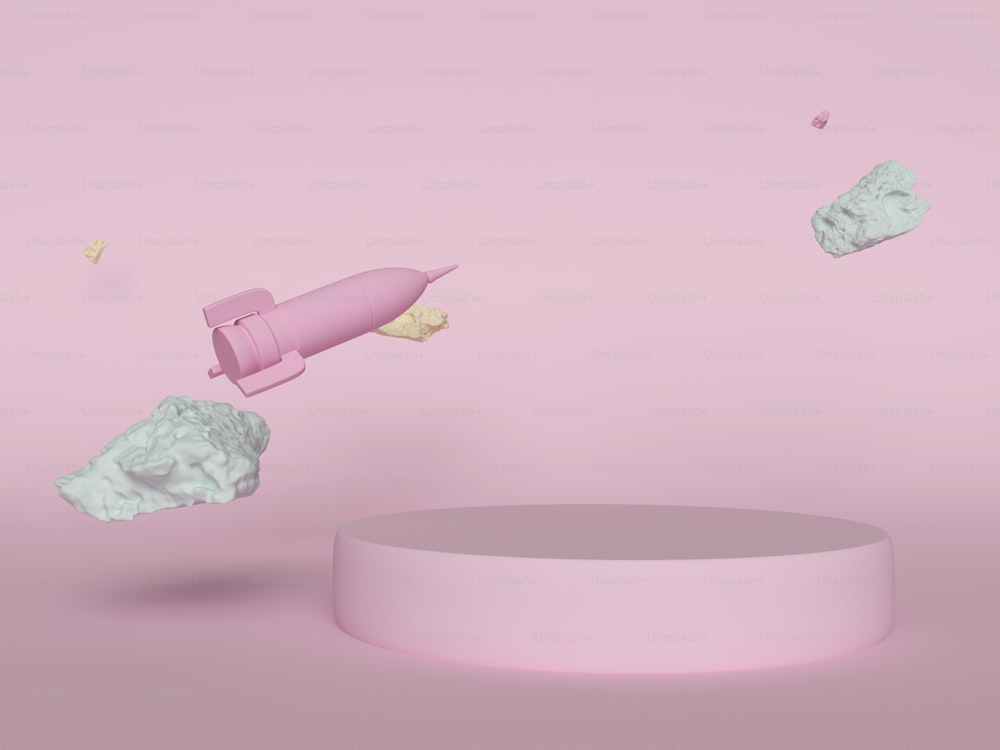 a pink object flying over a round object