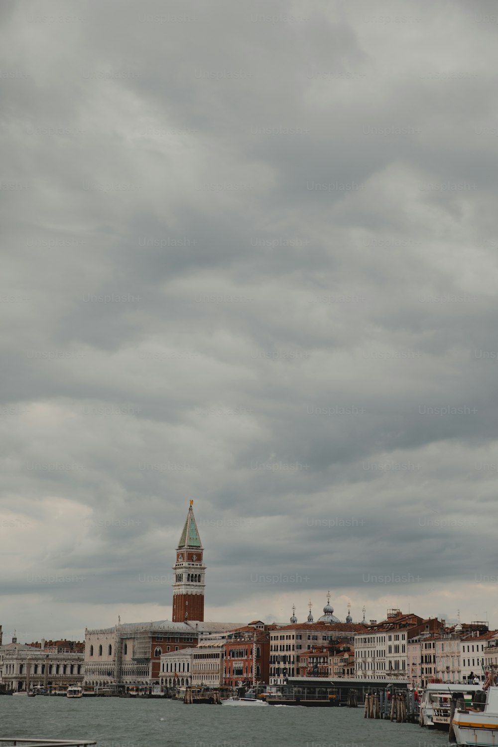 a large body of water with a clock tower in the background