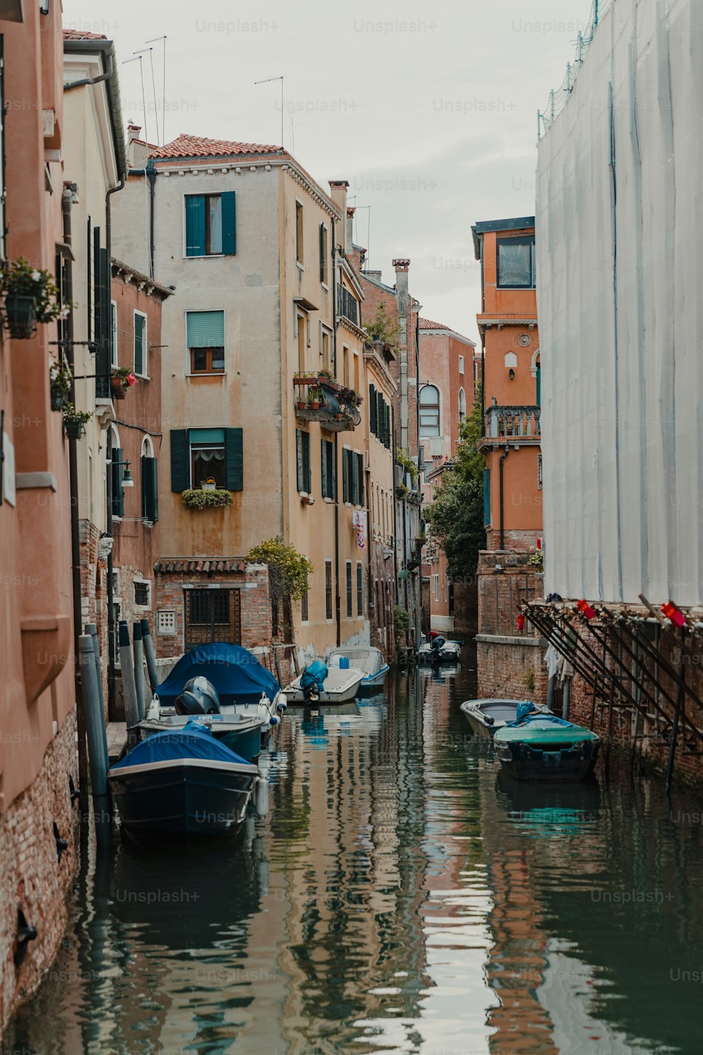 a waterway with boats and buildings on both sides