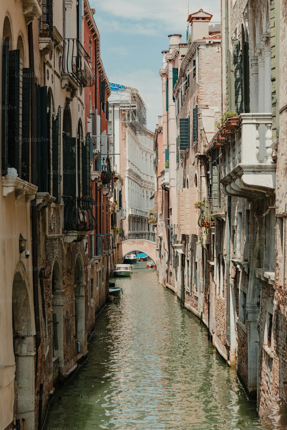 a canal running through a city next to tall buildings