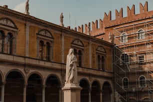a statue in front of a building with scaffolding around it