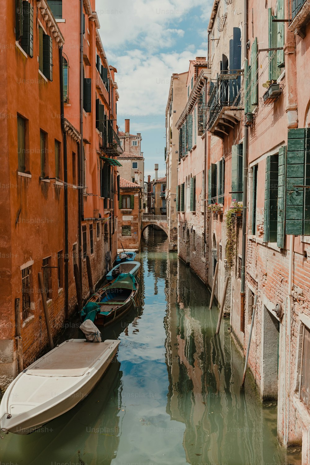 a boat is parked in a canal between two buildings