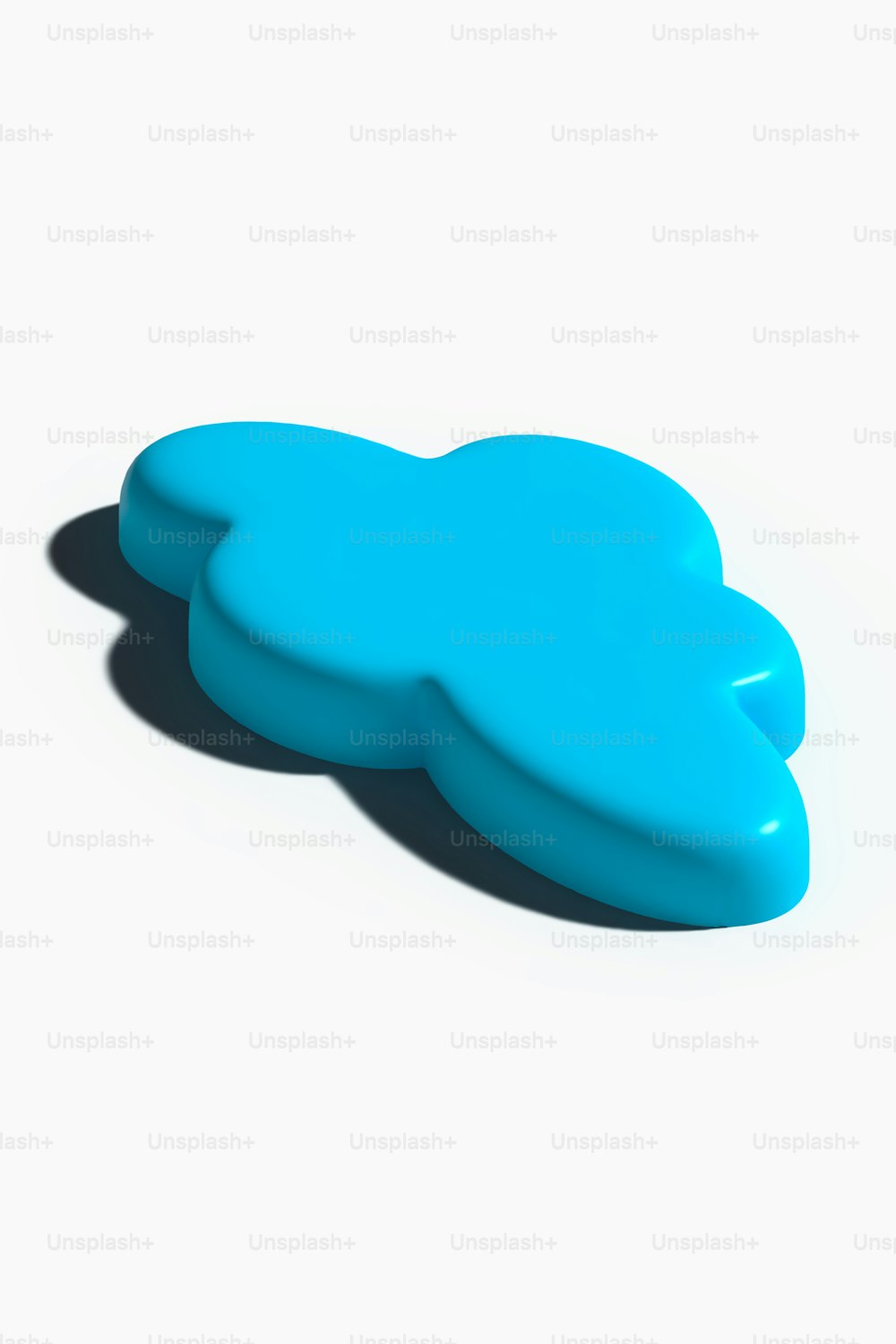 a blue cloud shaped object on a white surface