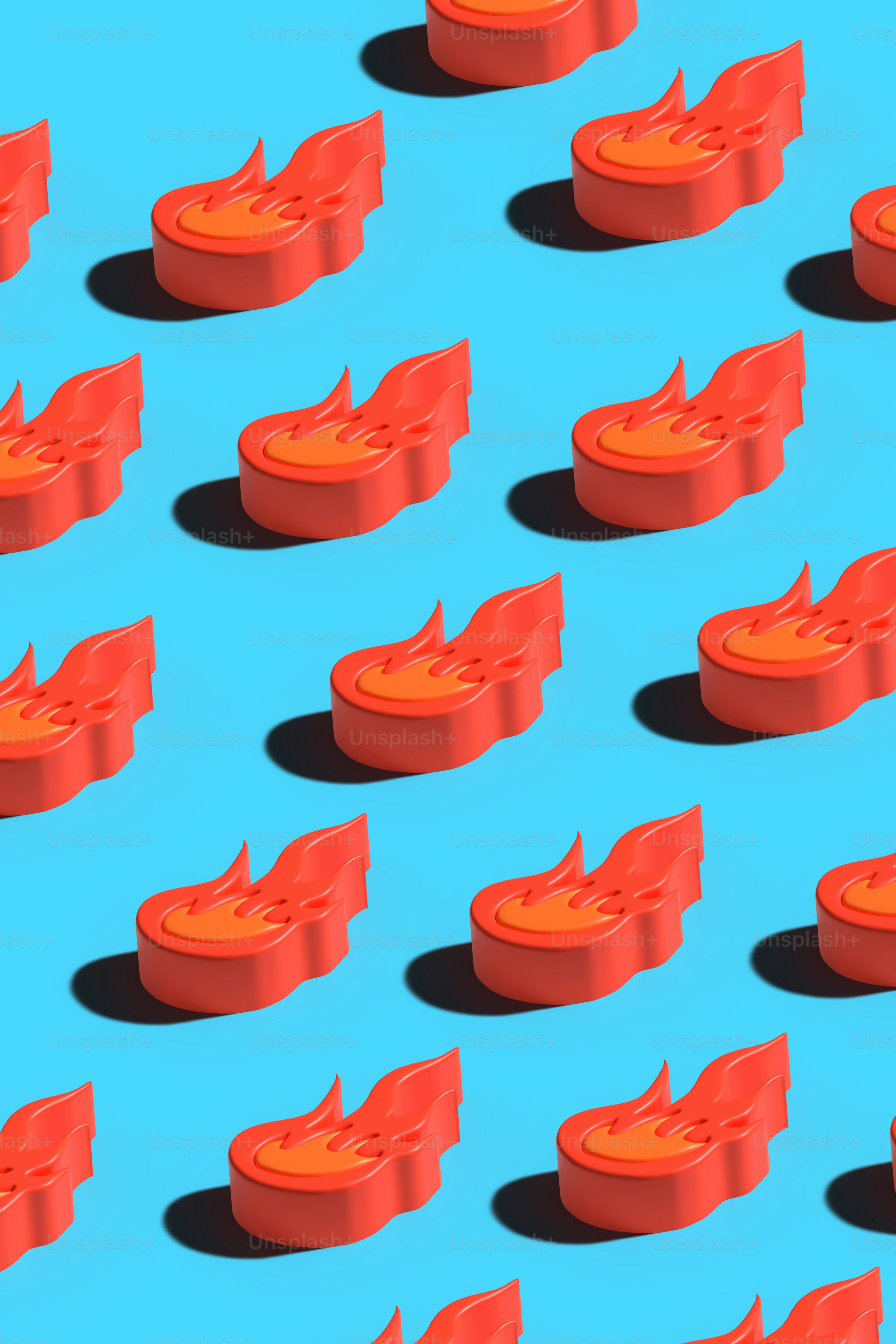 青い表面の上に置かれたオレンジ色のオブジェクトのグループ