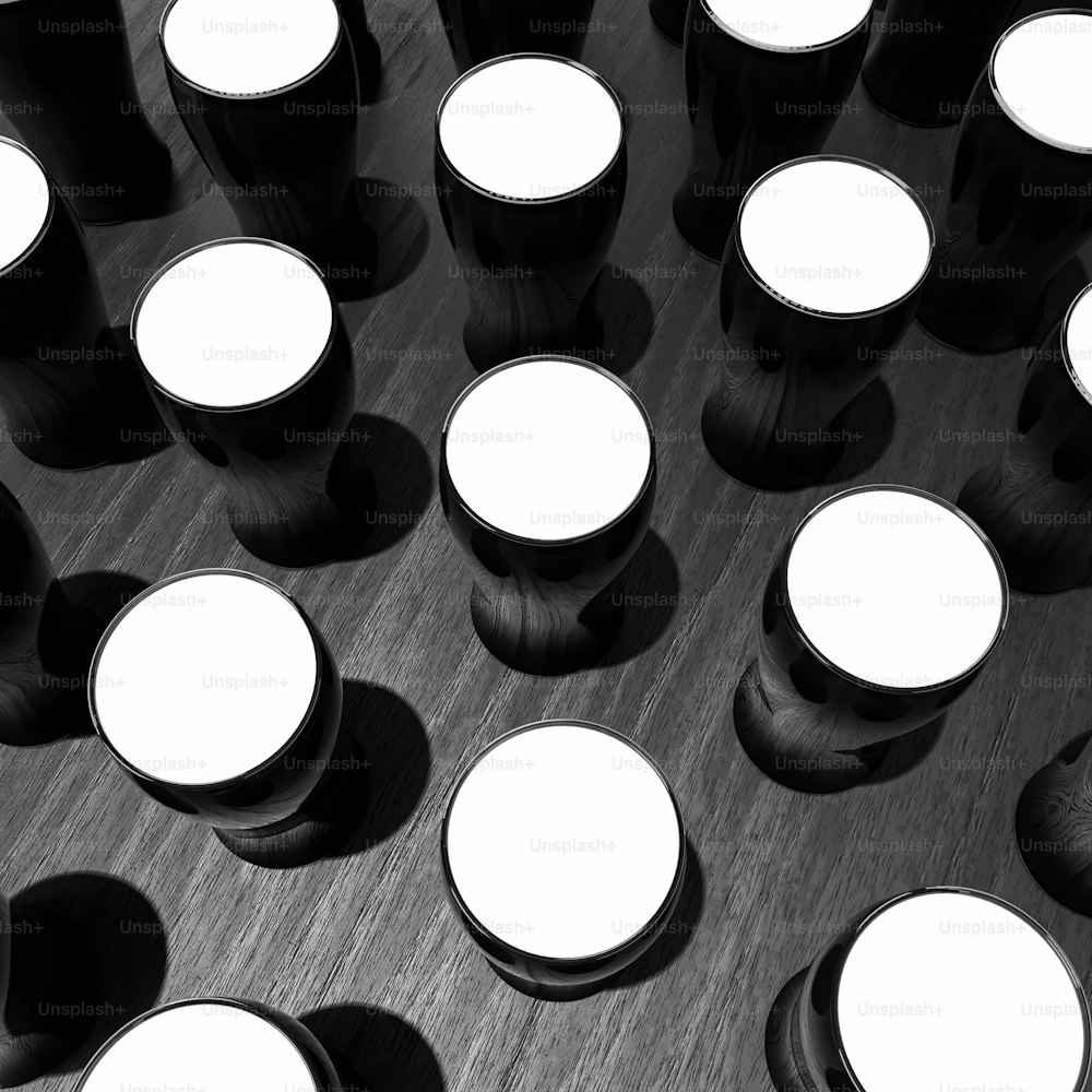 a black and white photo of a bunch of cups