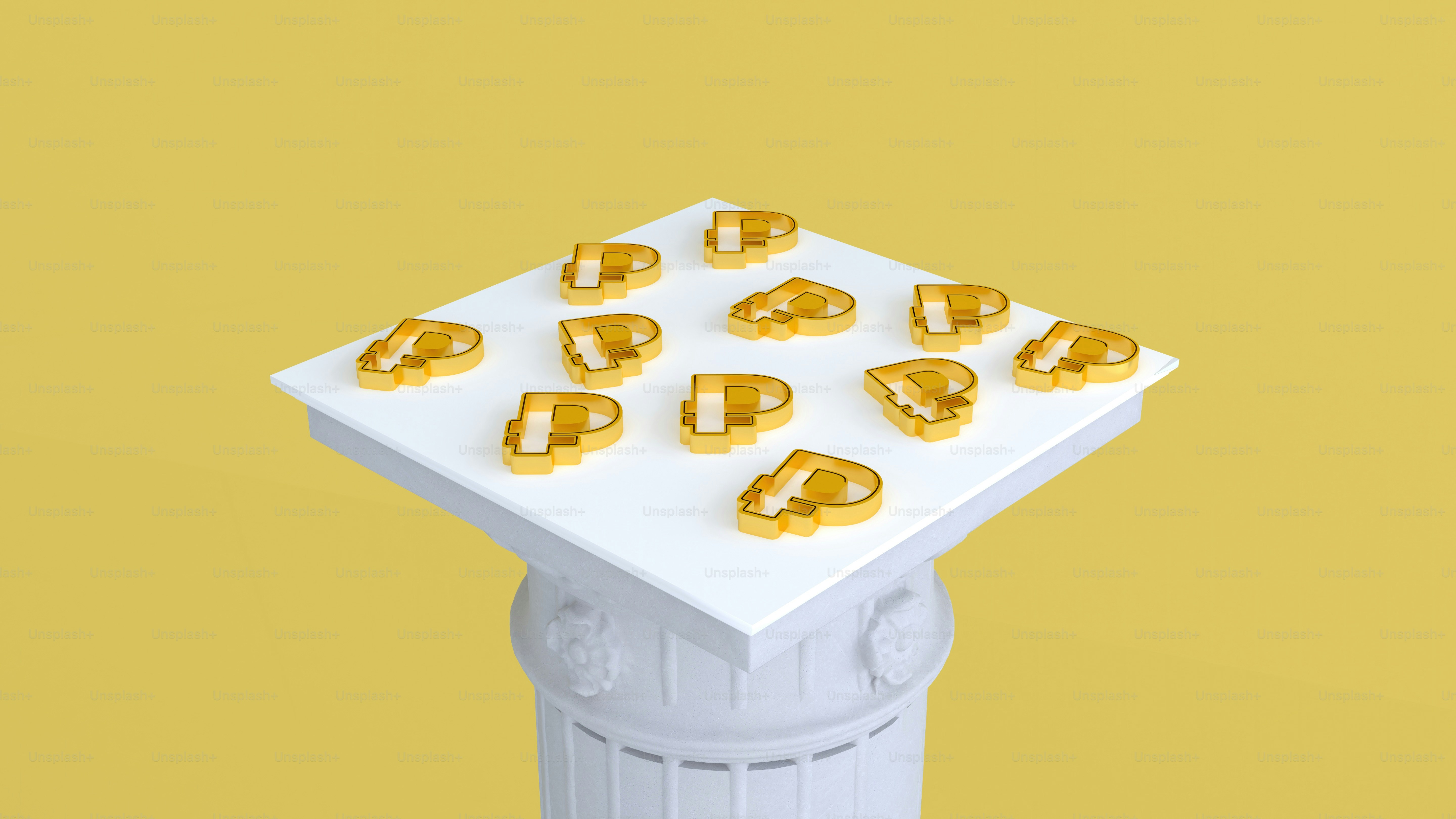 a white table topped with gold letters on top of a yellow background