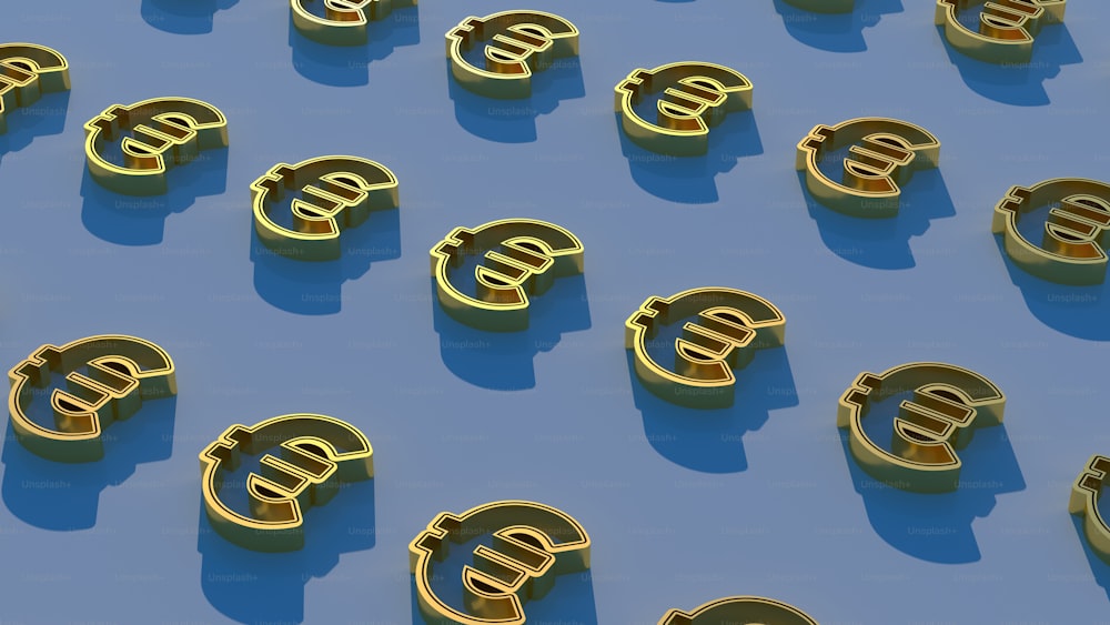 a group of gold dollar signs sitting on top of a blue surface