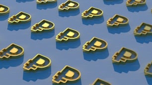 Un groupe de bitcoins dorés assis sur une surface bleue