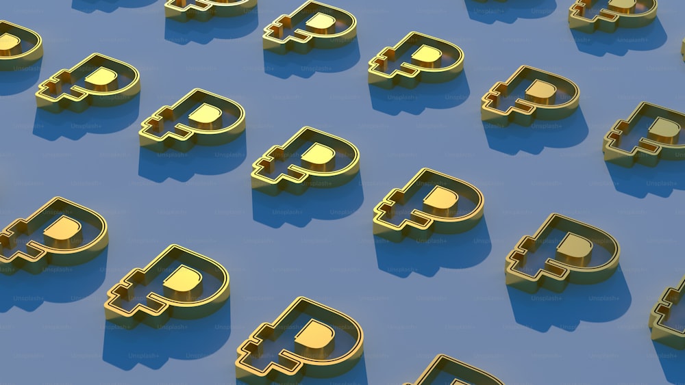 a group of golden bitcoins sitting on top of a blue surface