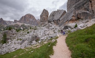 a couple of people that are walking on a trail