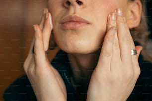 a woman holding her hands to her face