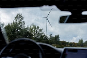 a view of a wind turbine from inside a car