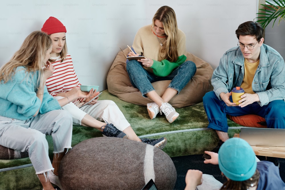 a group of people sitting on bean bag chairs