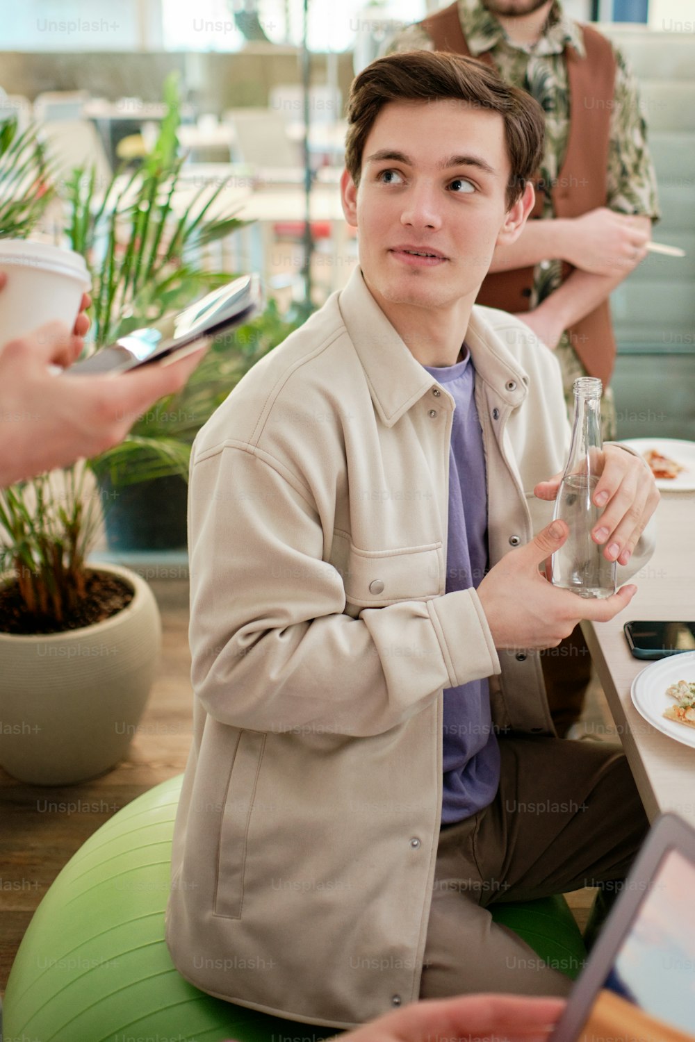 a man sitting at a table with a glass of wine