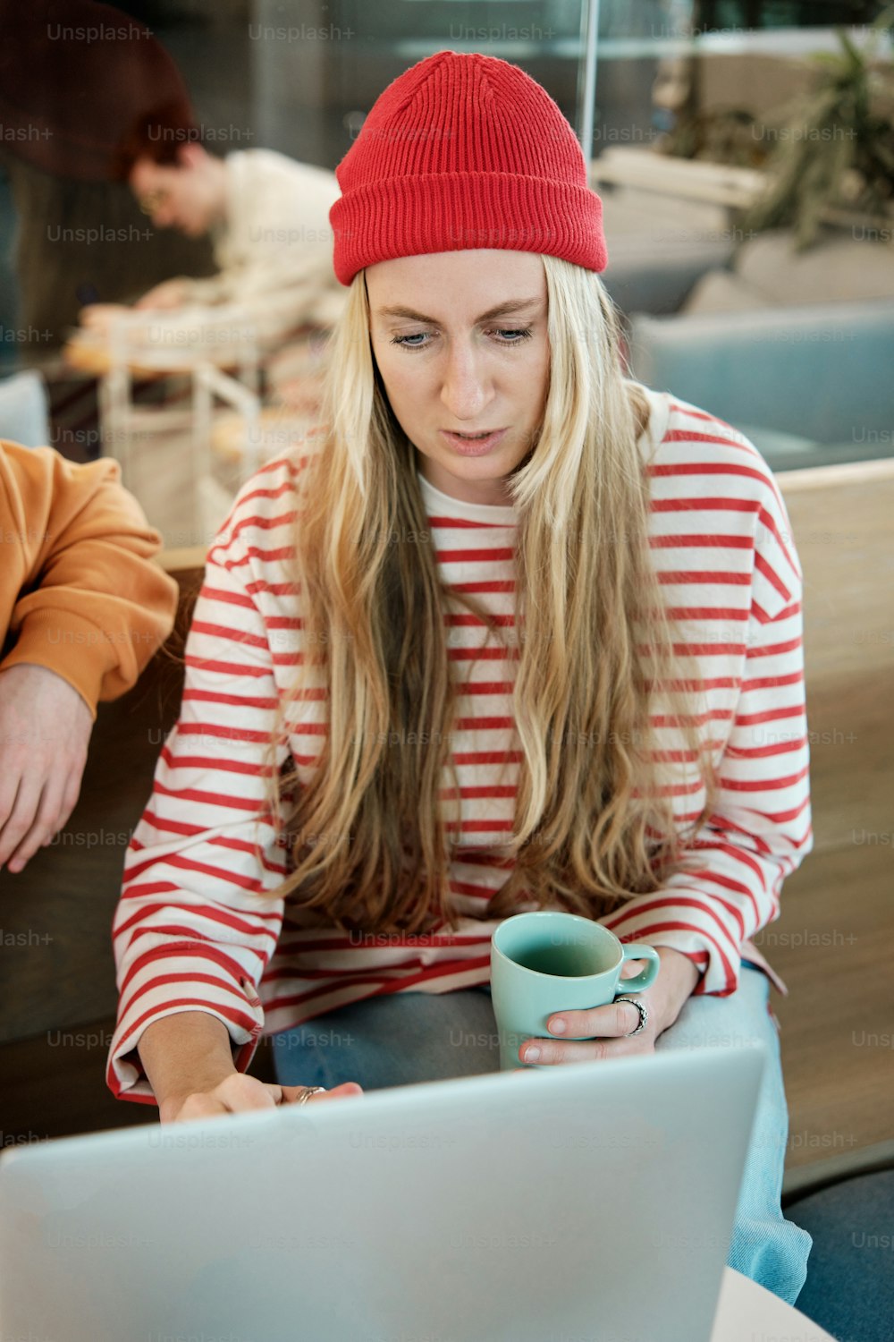 a woman sitting in front of a laptop computer