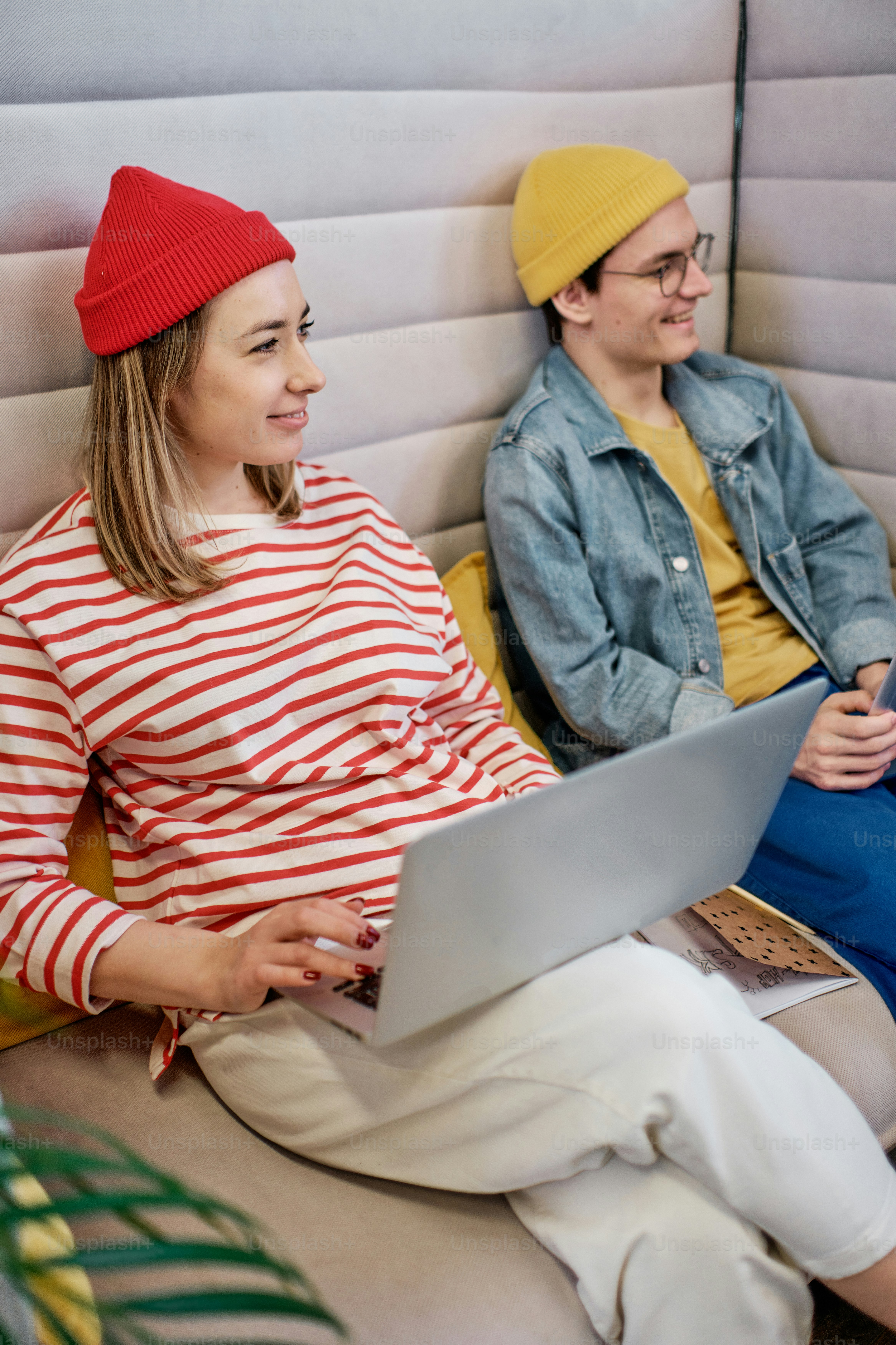 a man and a woman sitting next to each other on a couch