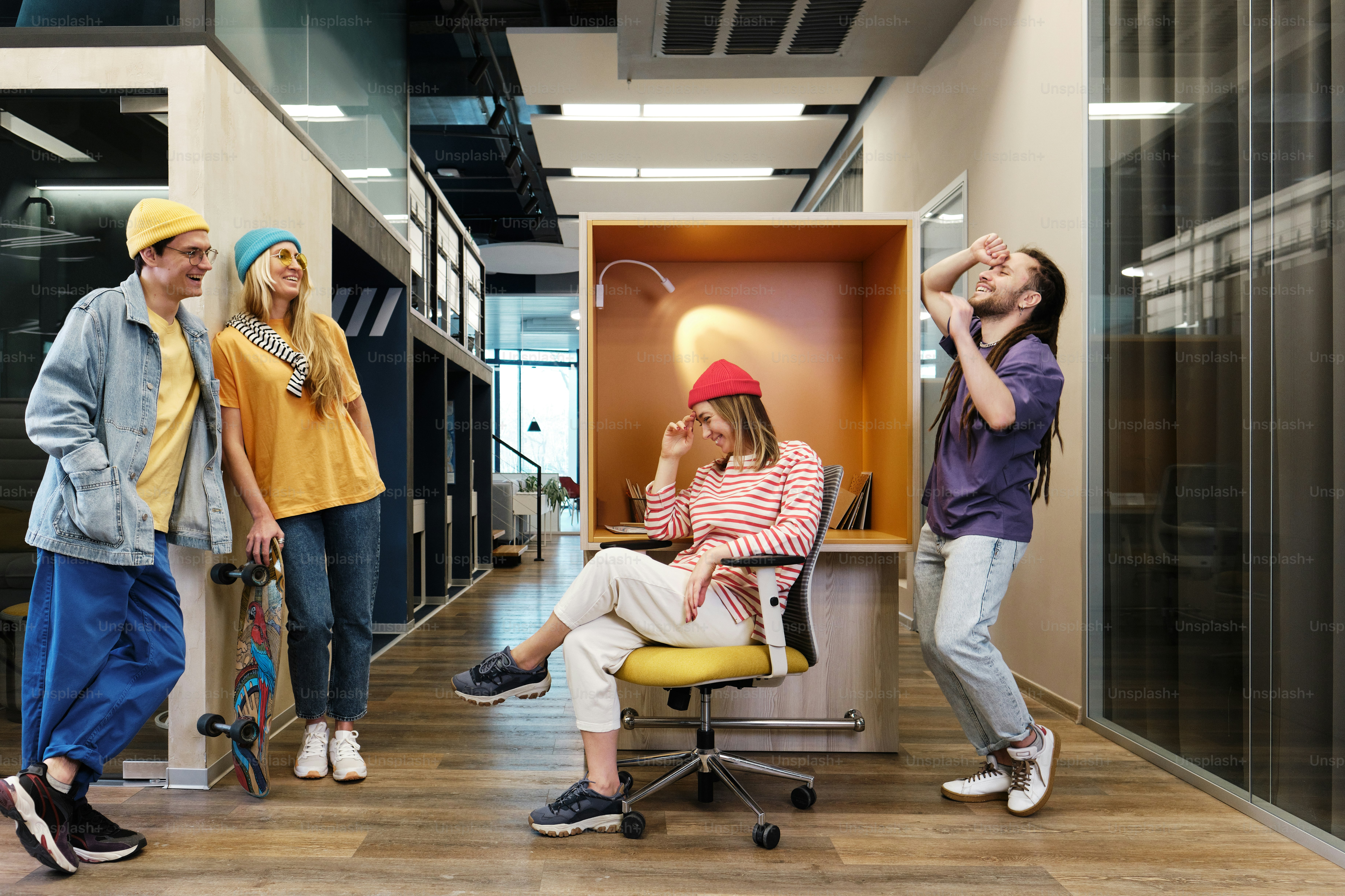 a group of people standing and sitting around a desk