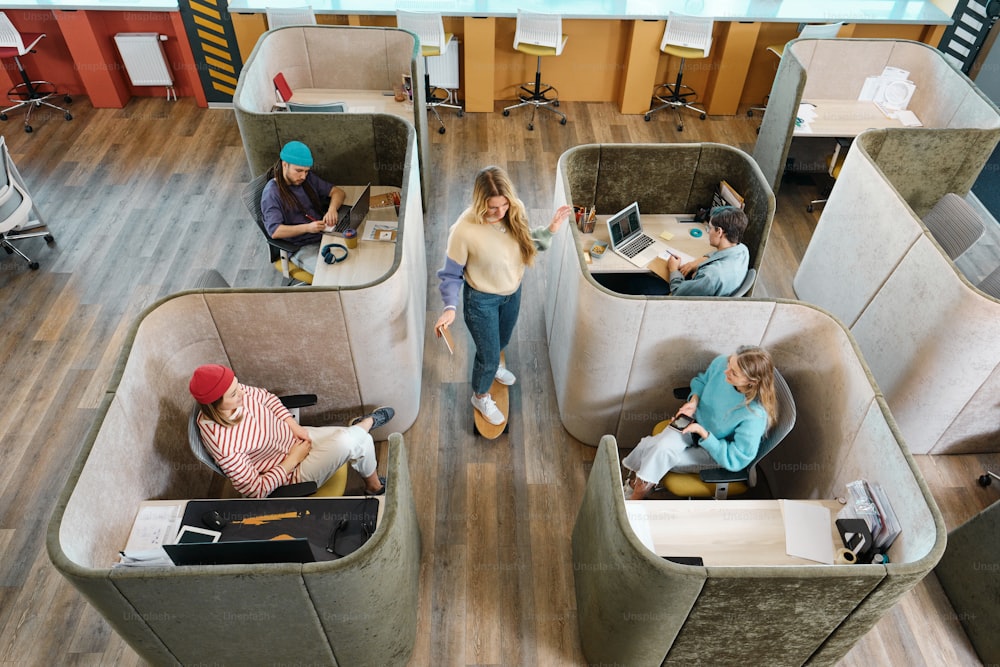 a group of people sitting at desks in a room